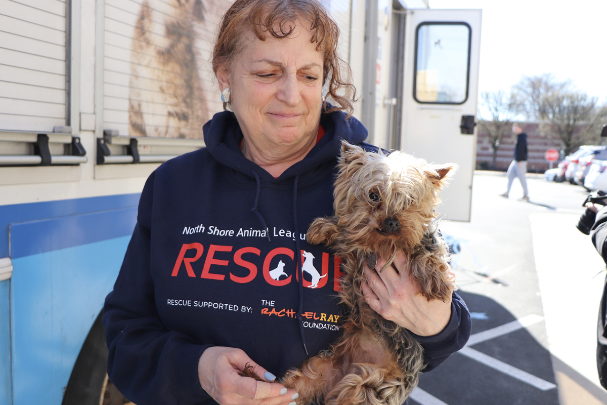 a woman holding a dog