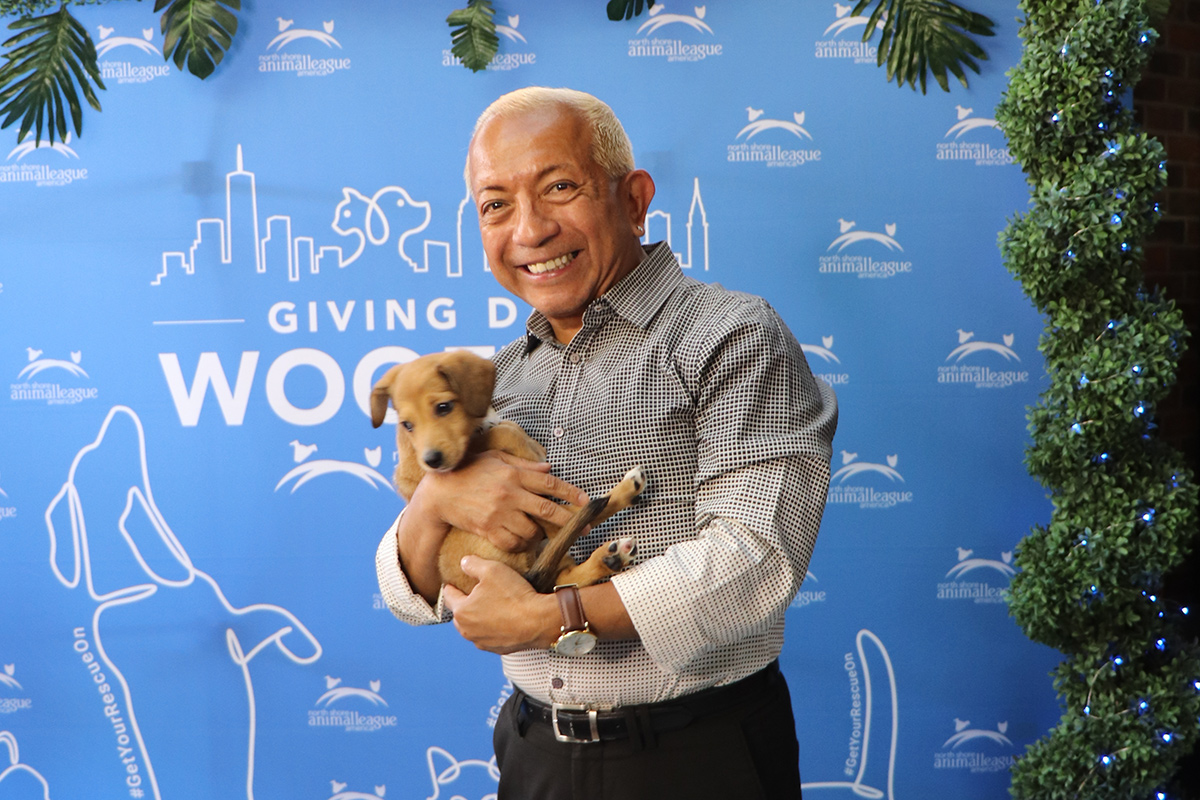 a man holding a puppy