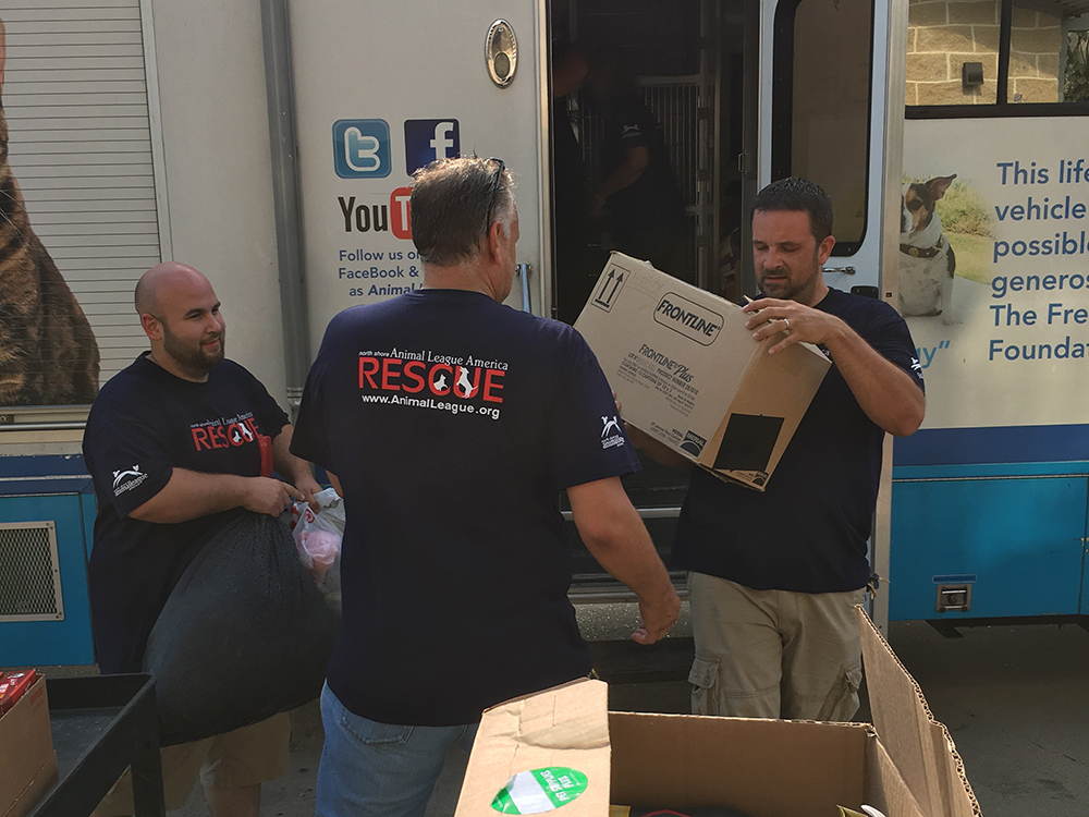 rescue-harvey-update-unloading-090417 a group of men carrying boxes