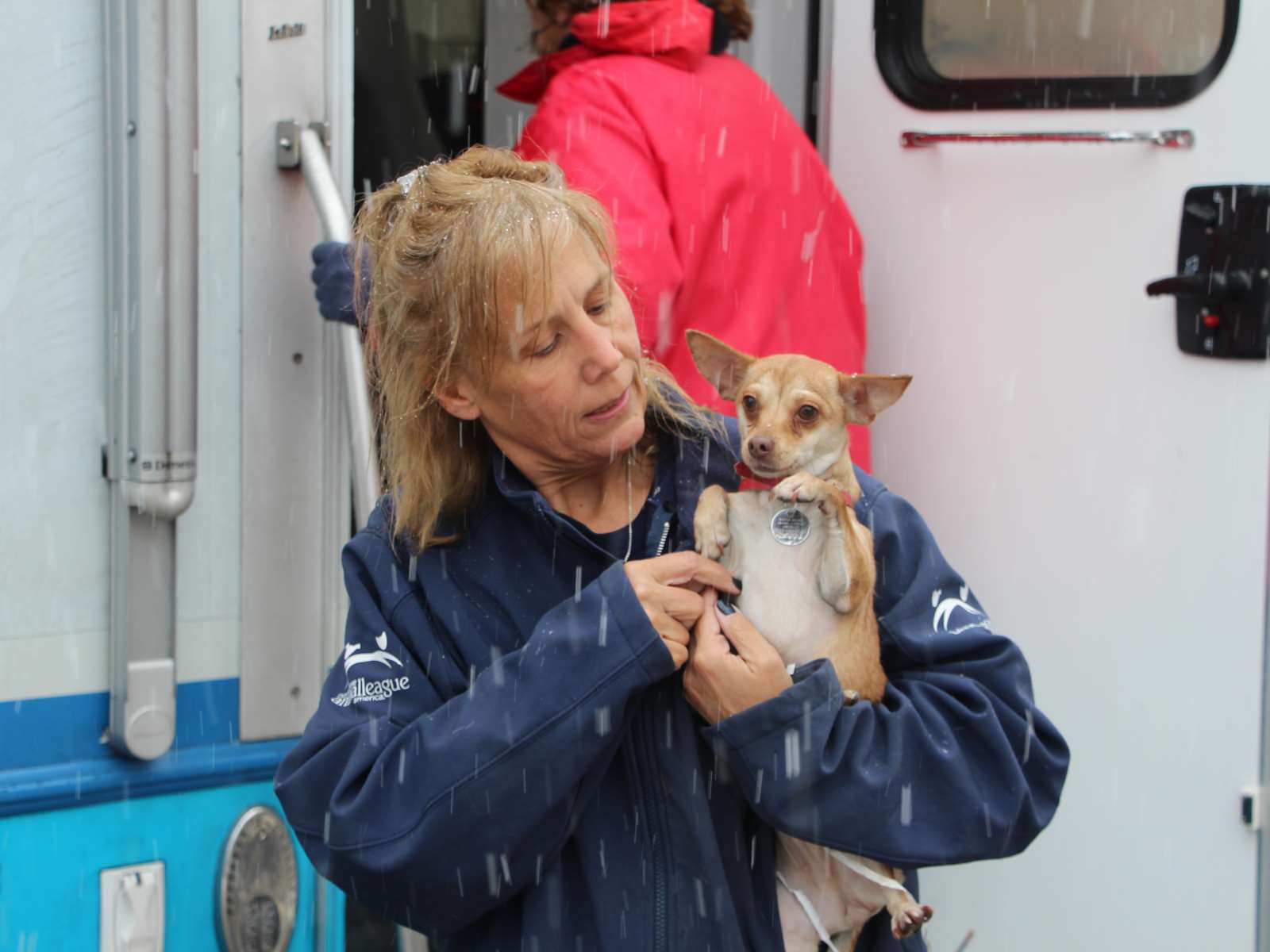 rescue-oklahoma-midwest-120917-IMG_4687 a woman holding a dog in the rain