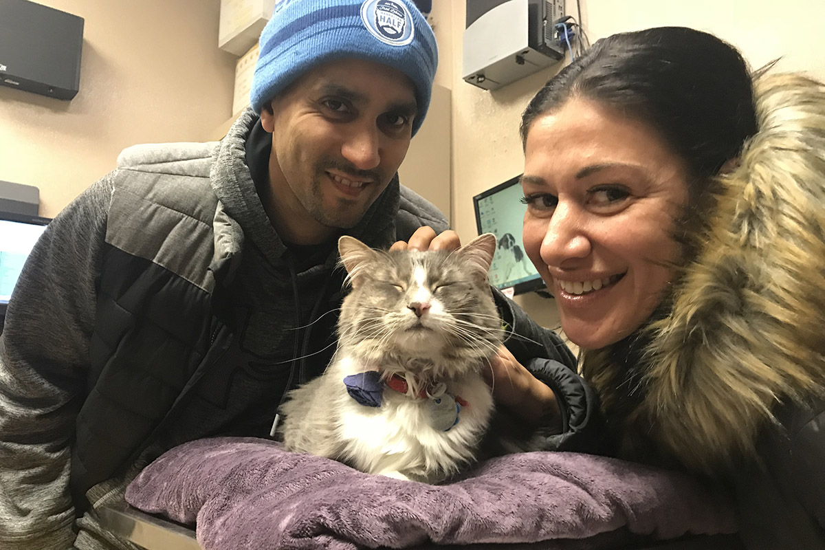 adoption-story-sponsor-pet-pretty-kitty-with-adopters-img1868 a man and woman with a cat