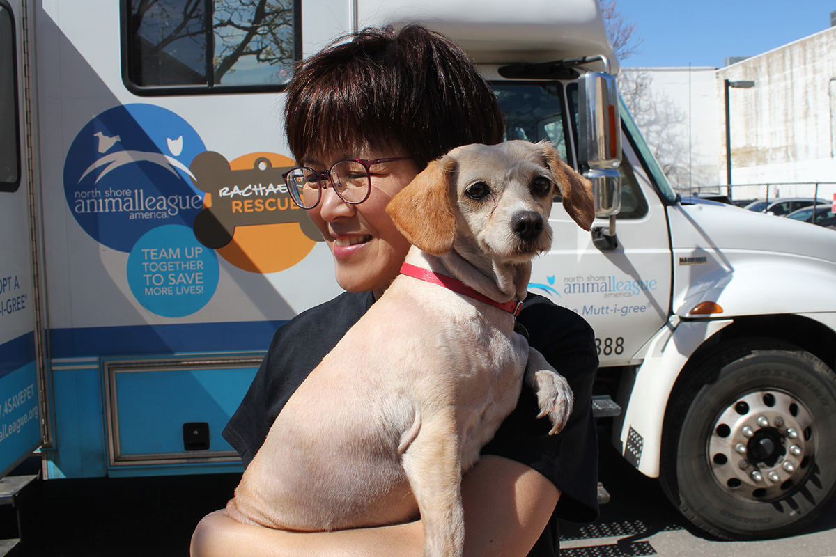 a woman holding a dog