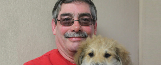 a man with a mustache and a dog