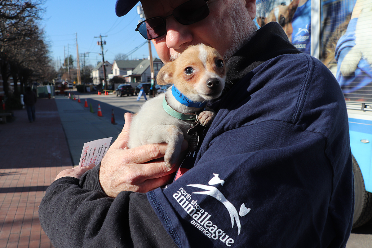 a man holding a small dog