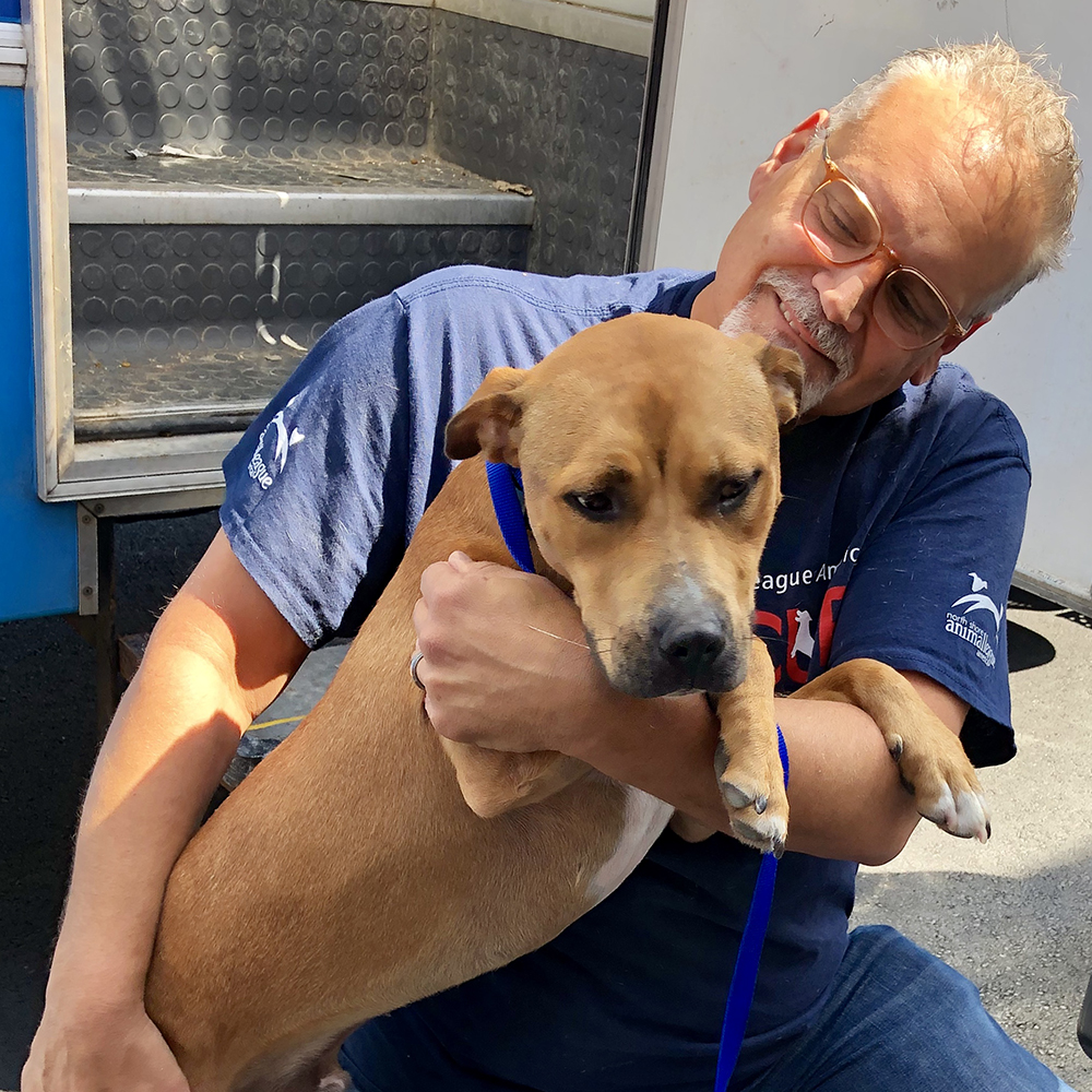 a man holding a dog