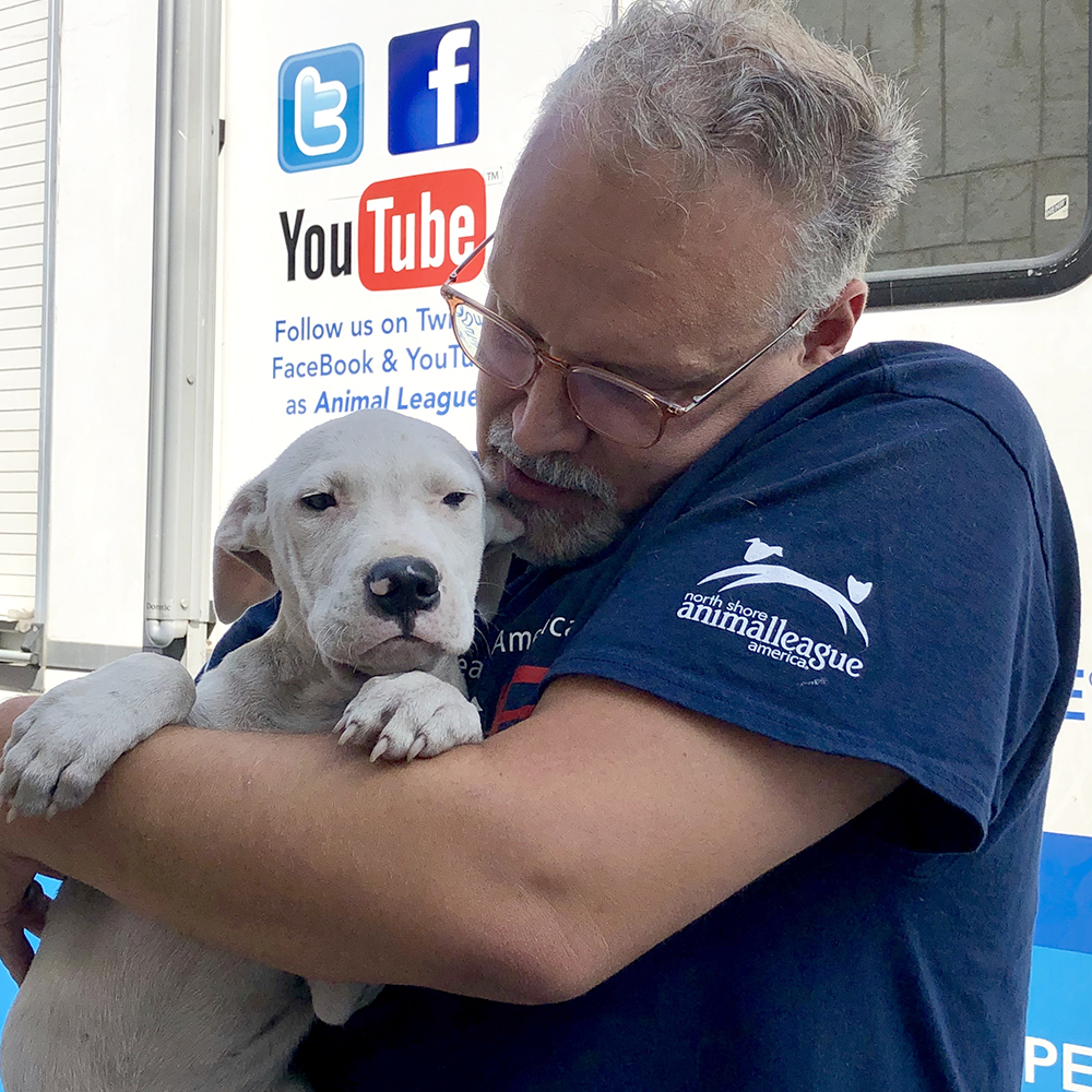 a man holding a dog