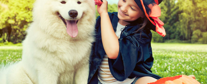 a girl petting a dog
