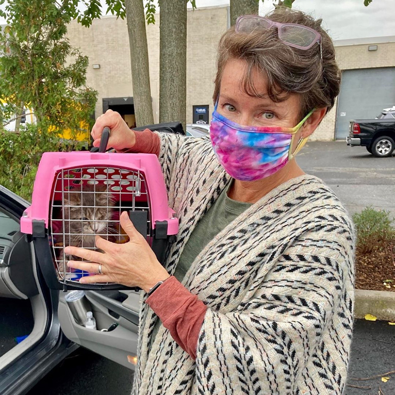 beth-blog-oct2020-frankie-fluff-marvel-adopted a woman wearing a face mask holding a cat in a carrier