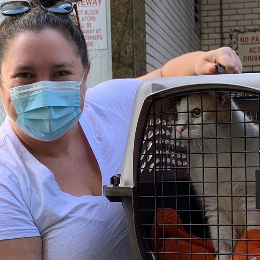 beth-blog-oct2020-grammie-adopted a woman wearing a mask and holding a cat in a cage