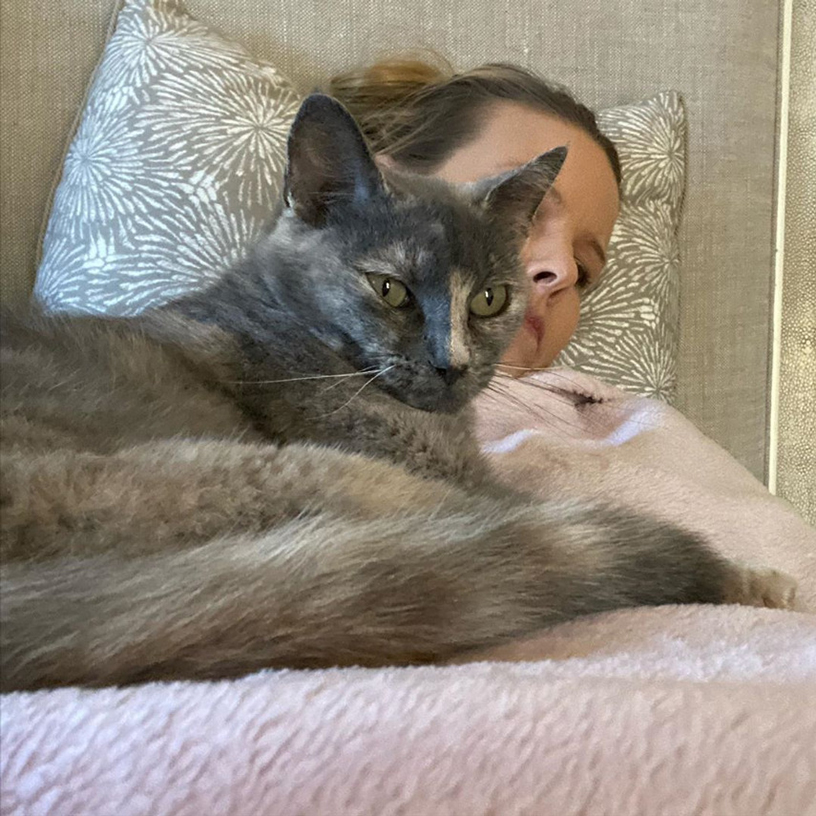 beth-blog-oct2020-mama-bessie-with-beth a woman sleeping with a cat