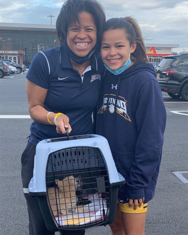 beth-blog-dec2020-tiramasu-and-tamale-adopters a woman and a girl with a dog in a carrier