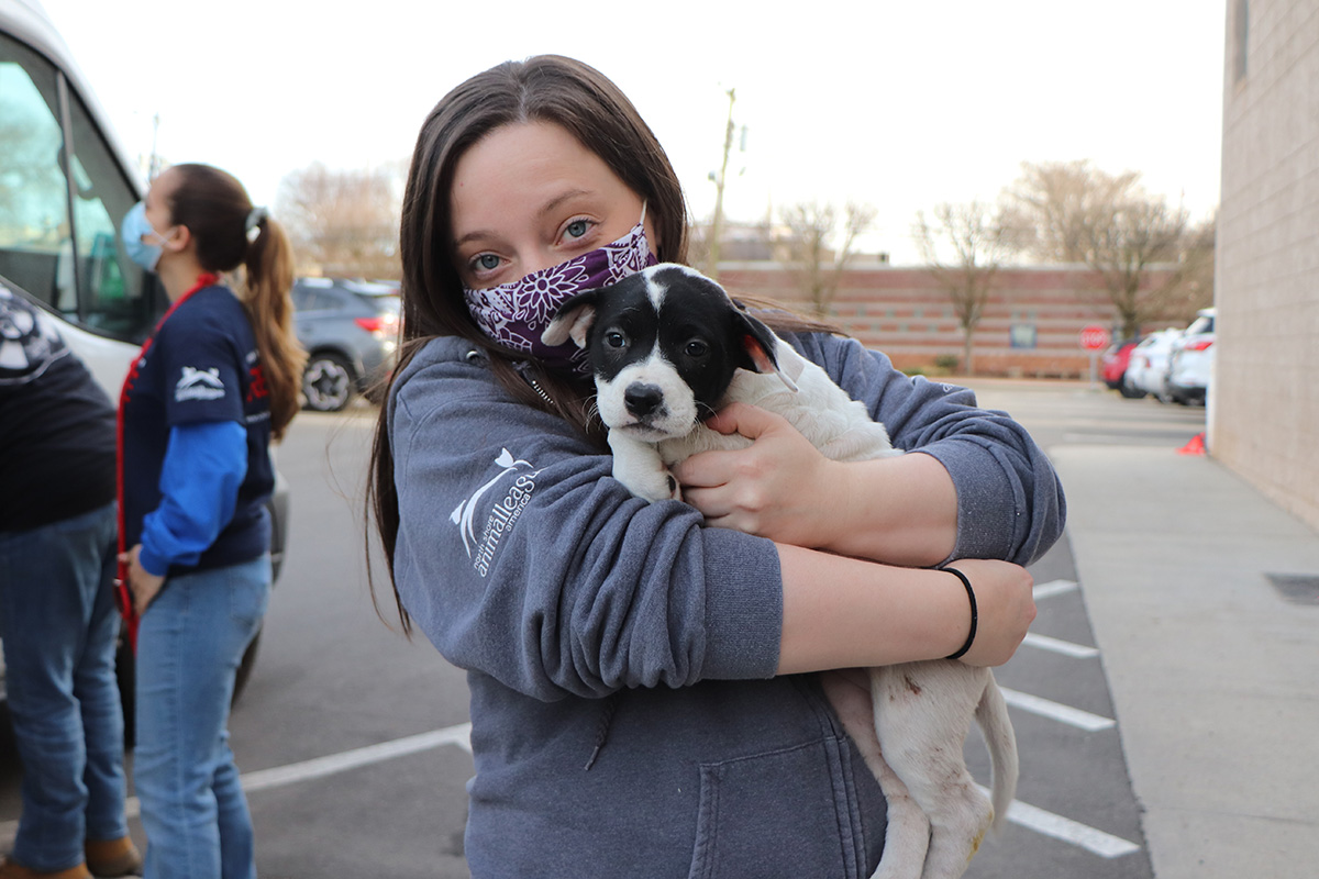 a woman holding a dog