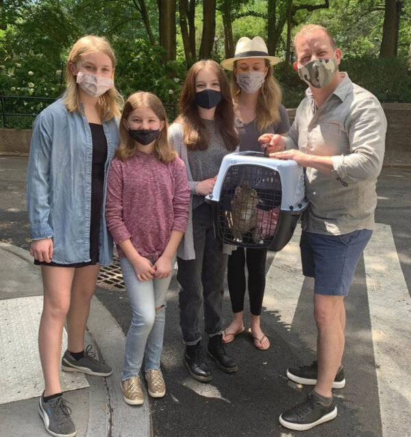 a group of people wearing face masks standing on a street