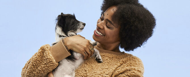 a woman holding a dog