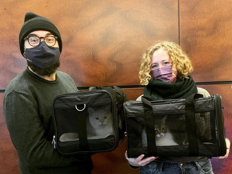 beth-blog-march2022-prince-and-pickleball-adopters a man and woman holding bags with cats inside