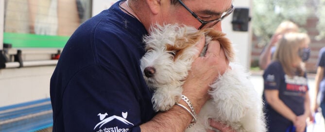 a man holding a dog