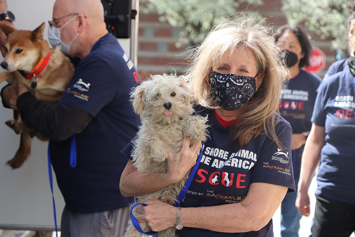 a woman holding a dog