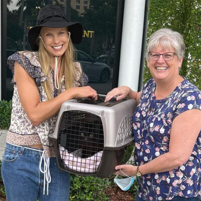 beths-blog-june2022-glory-adopted two women holding a cat in a cage