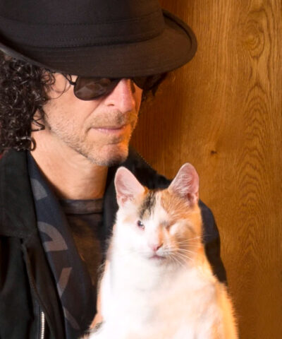 beths-blog-june2022-howard-and-bella a man wearing a hat and sunglasses holding a cat