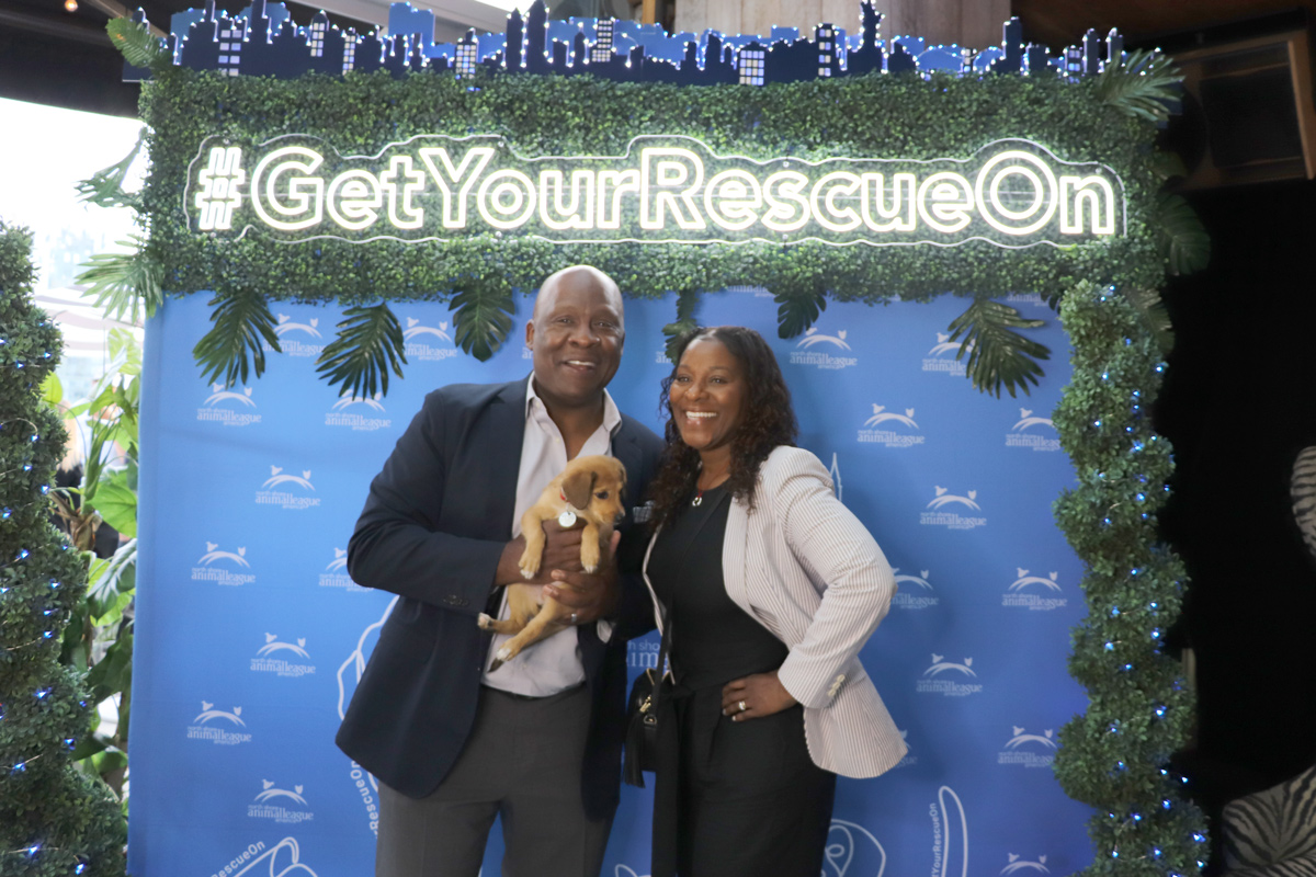 a man and woman holding a puppy