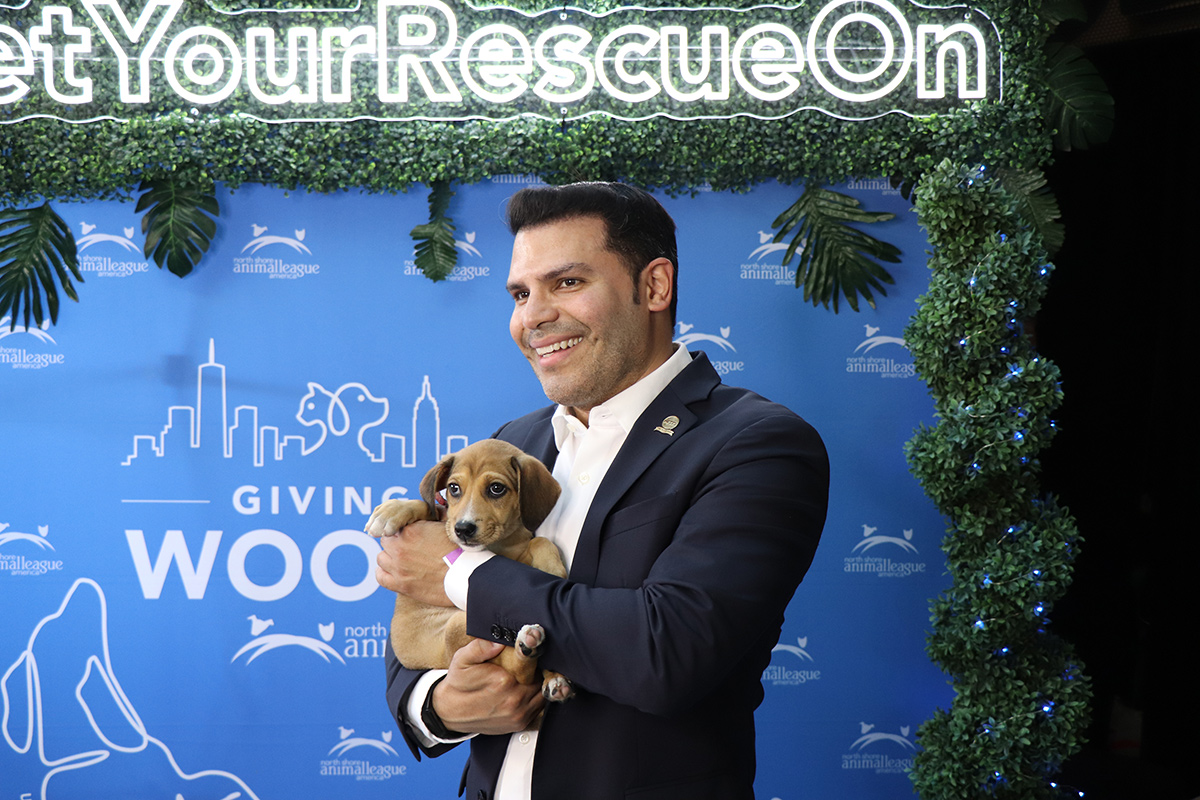a man holding a puppy