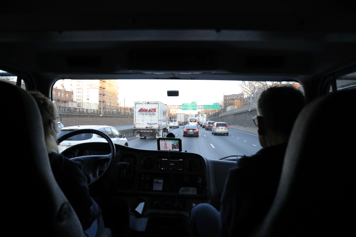 a view from inside of a car of a road with cars and buildings