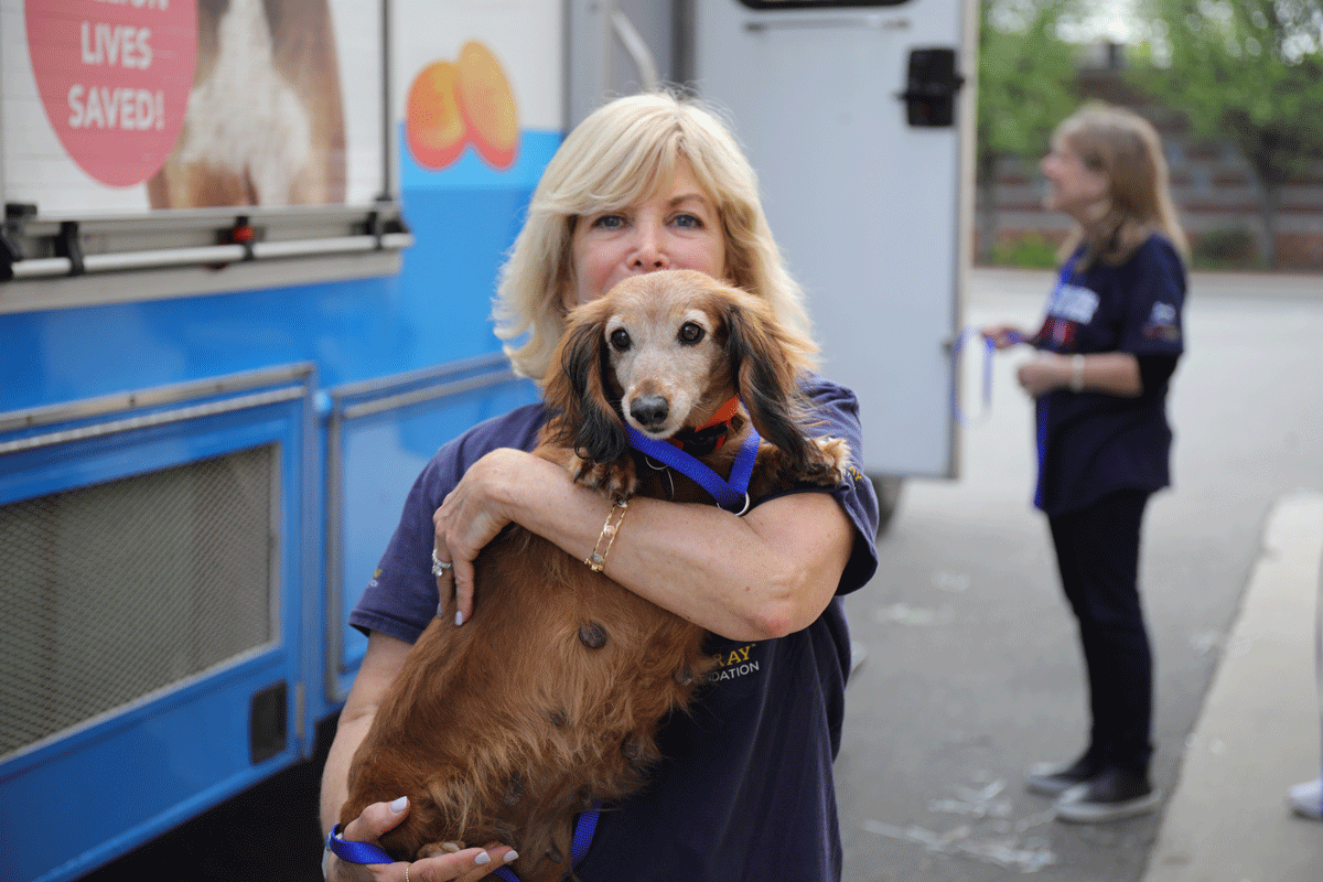 a woman holding a dog
