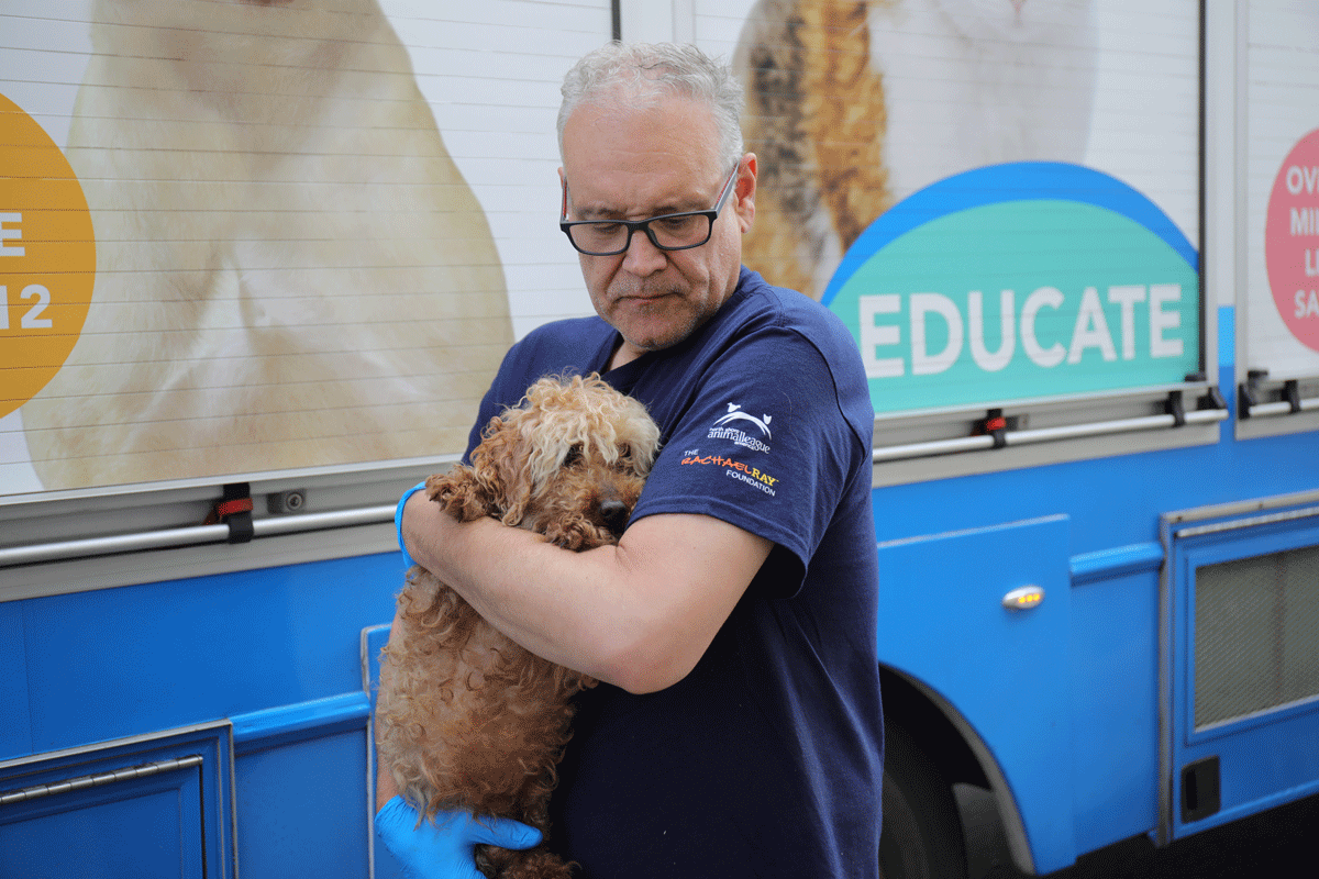 a man holding a dog