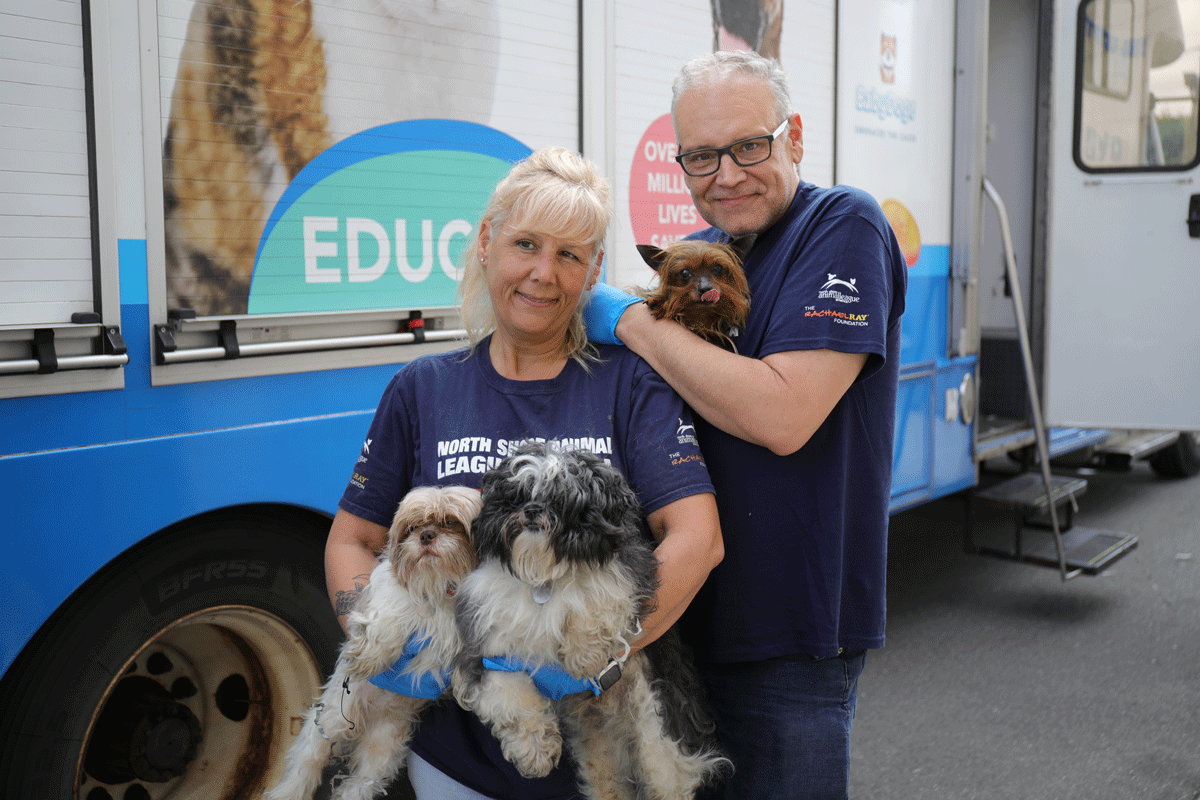 a man and woman with dogs
