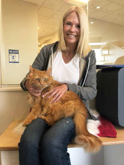 beth-blog-june2023-fluki-adopter a woman holding a cat
