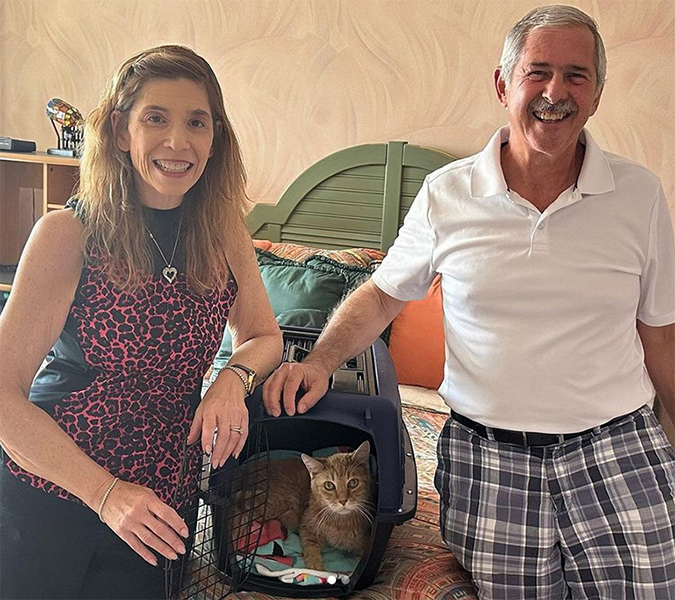 beth-blog-june2023-tazz-adopters-v2 a man and woman standing next to a cat in a carrier