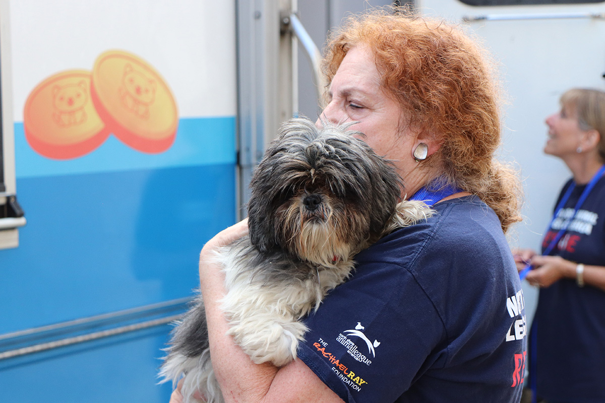 a woman holding a dog