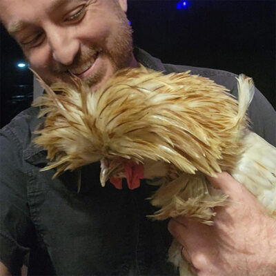 beth-blog-nov-ralph-the-rooster a man holding a chicken