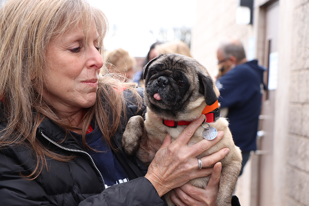 a woman holding a dog
