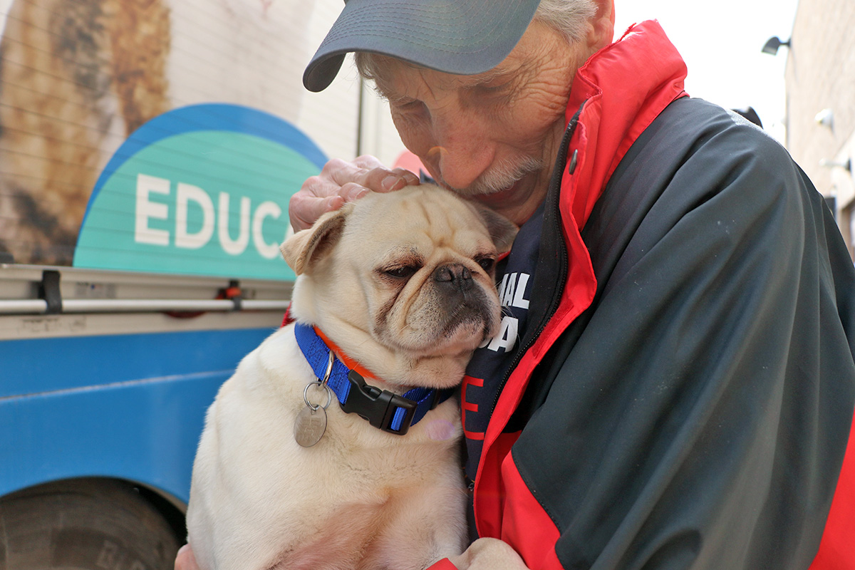 a man holding a dog