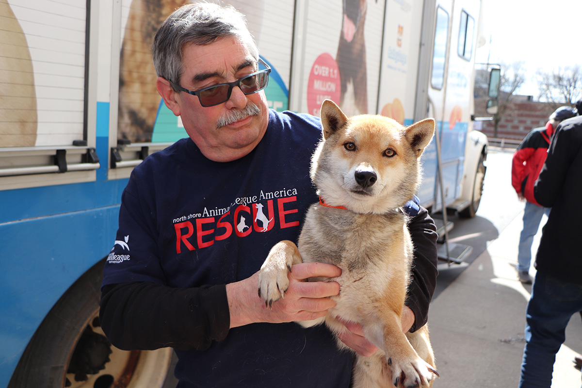a man holding a dog