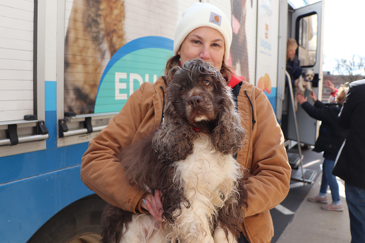 a woman holding a dog