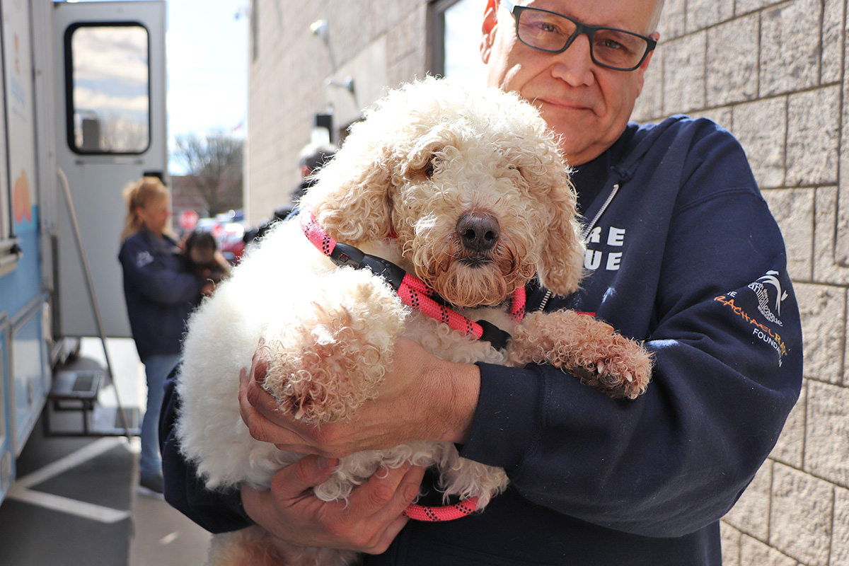 a man holding a dog