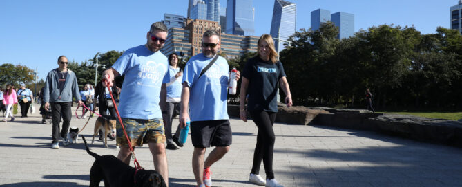 a group of people walking a dog