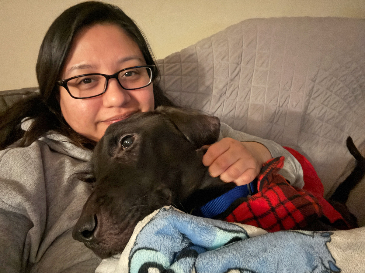 a woman holding a dog